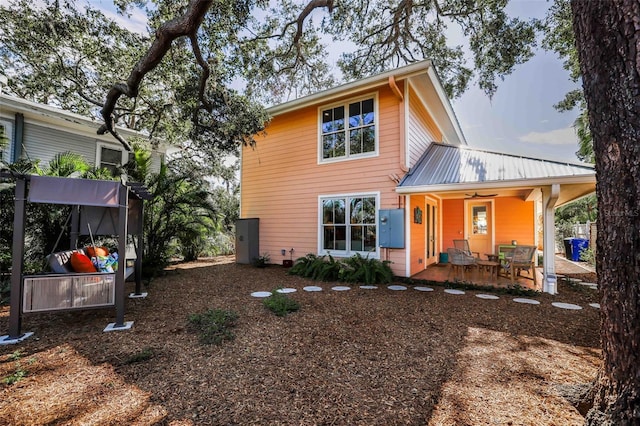 rear view of house with ceiling fan