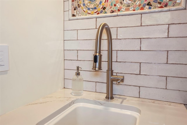 room details with light stone counters and a sink