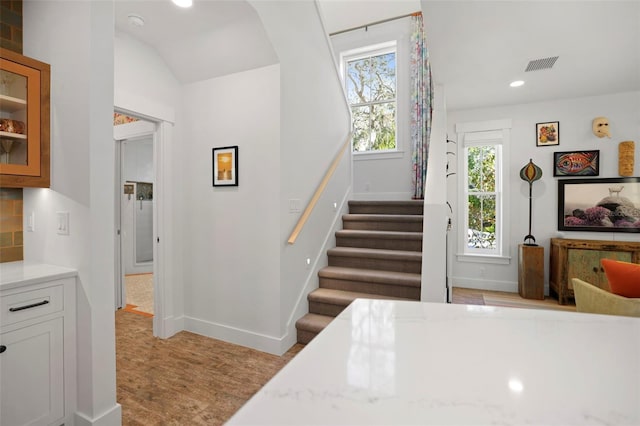 stairs featuring recessed lighting, visible vents, baseboards, and wood finished floors