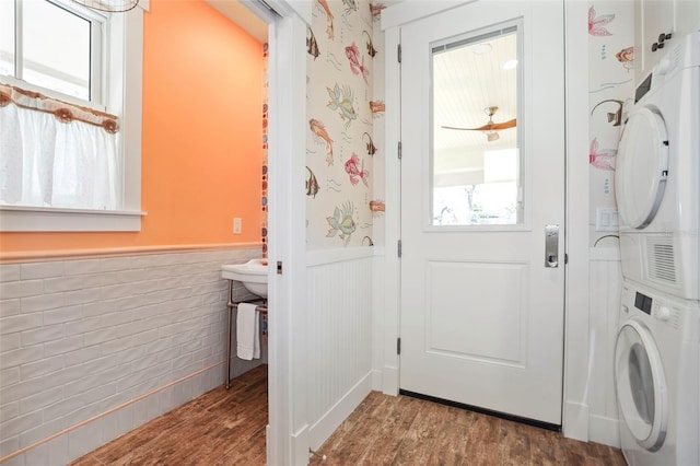 interior space featuring hardwood / wood-style flooring and stacked washer and clothes dryer