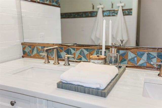 bathroom featuring vanity and decorative backsplash