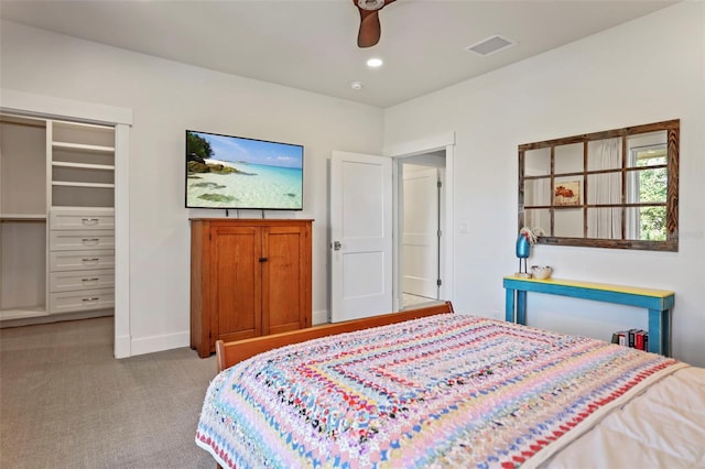 carpeted bedroom with ceiling fan and a closet