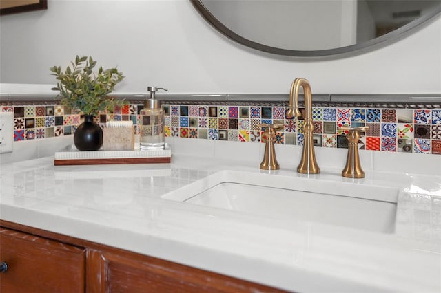 room details featuring decorative backsplash and a sink