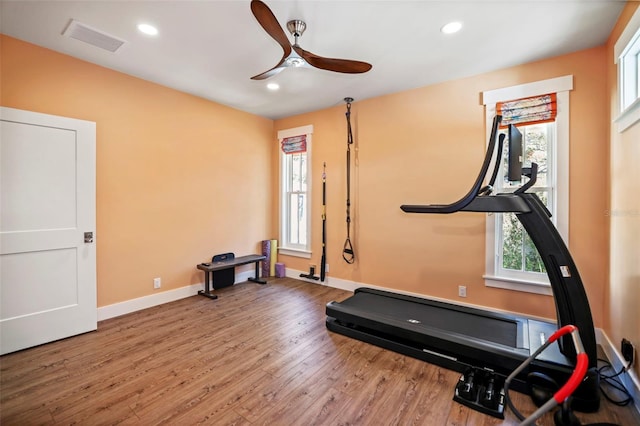 exercise room featuring recessed lighting, a ceiling fan, baseboards, visible vents, and light wood-style floors