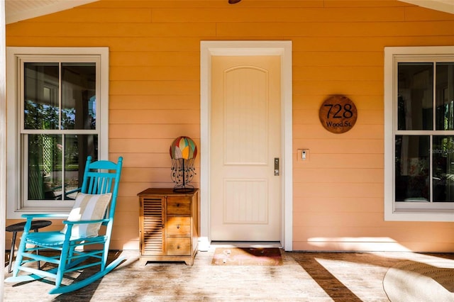 view of exterior entry with covered porch