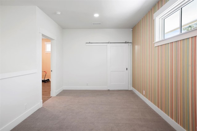 interior space with light carpet, visible vents, baseboards, and recessed lighting