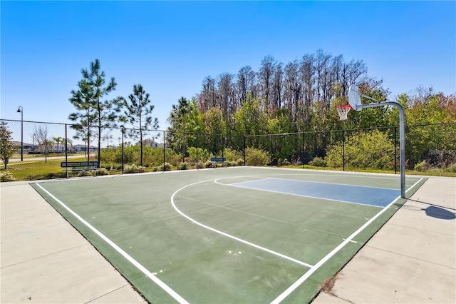 view of basketball court with community basketball court and fence