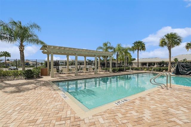 community pool with a patio area, fence, and a pergola