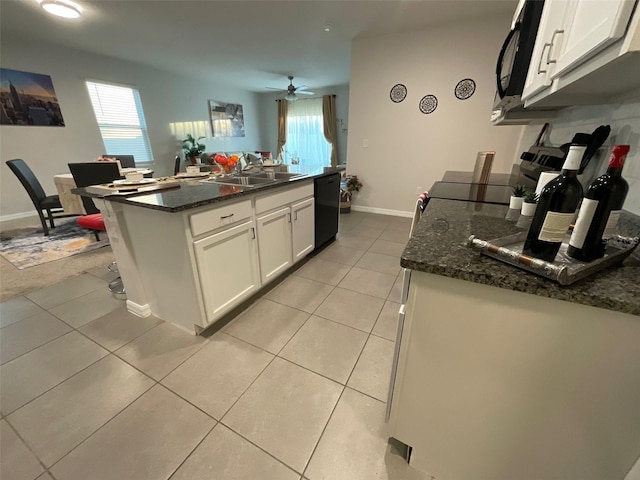 kitchen with light tile patterned floors, a kitchen island, black appliances, white cabinetry, and a sink