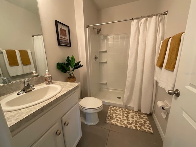 bathroom featuring curtained shower, vanity, toilet, and tile patterned floors