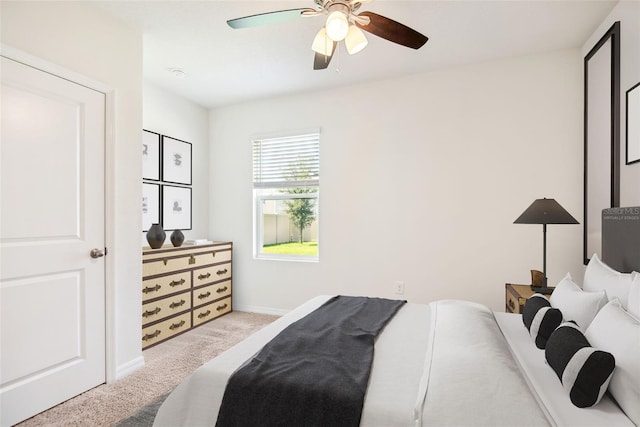 carpeted bedroom featuring a ceiling fan and baseboards