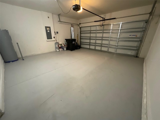 garage with a garage door opener and electric panel