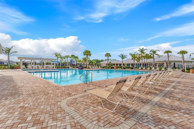 pool with a patio and a pergola