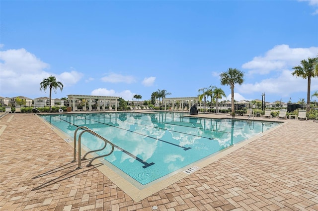 community pool with a pergola and a patio