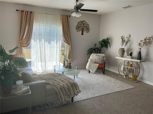 sitting room featuring ceiling fan, visible vents, a healthy amount of sunlight, and carpet