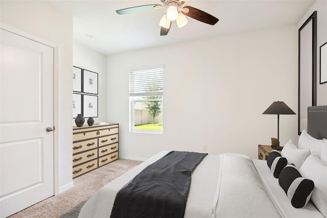 bedroom with ceiling fan, baseboards, and carpet
