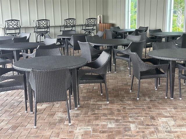 dining area featuring brick floor