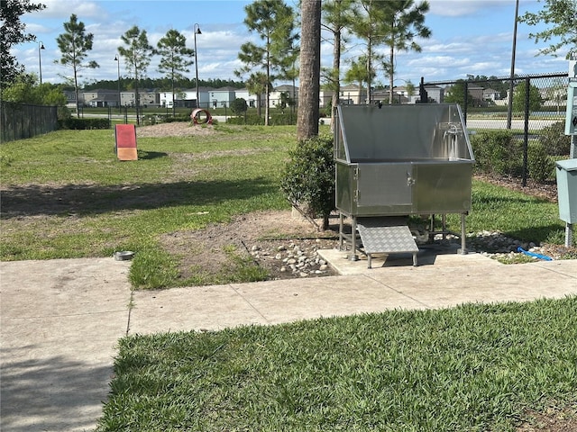 surrounding community featuring fence and a lawn
