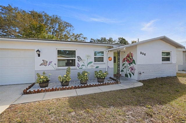 ranch-style home with a garage and stucco siding