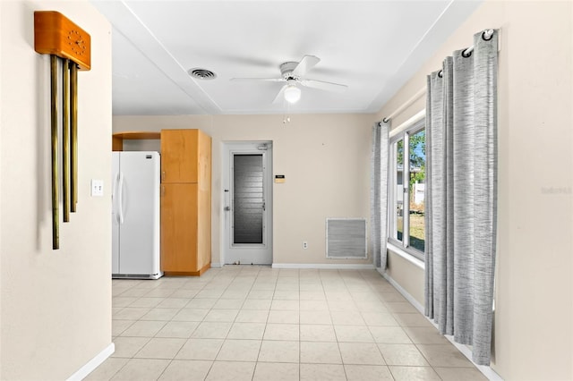 spare room featuring light tile patterned floors and ceiling fan