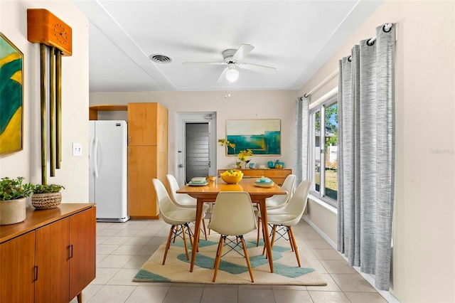 tiled dining room featuring ceiling fan