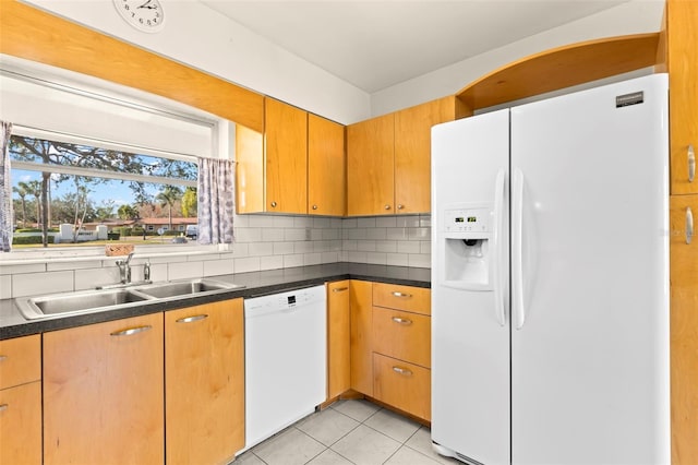 kitchen featuring sink, light tile patterned floors, backsplash, and white appliances