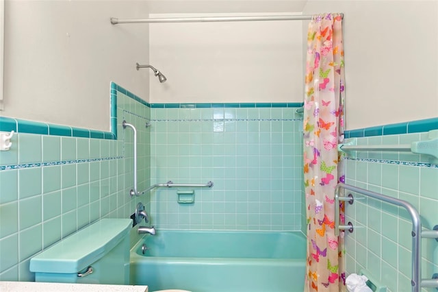 bathroom featuring tile walls, shower / bath combination with curtain, and toilet