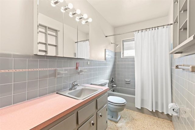 full bathroom with toilet, vanity, shower / bathtub combination with curtain, and tile walls