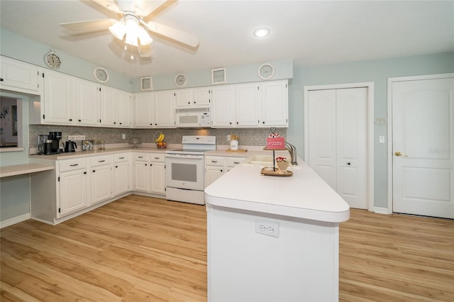 kitchen with white cabinetry, sink, and white appliances