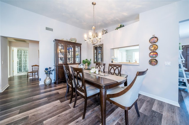 dining room featuring a notable chandelier and dark hardwood / wood-style flooring