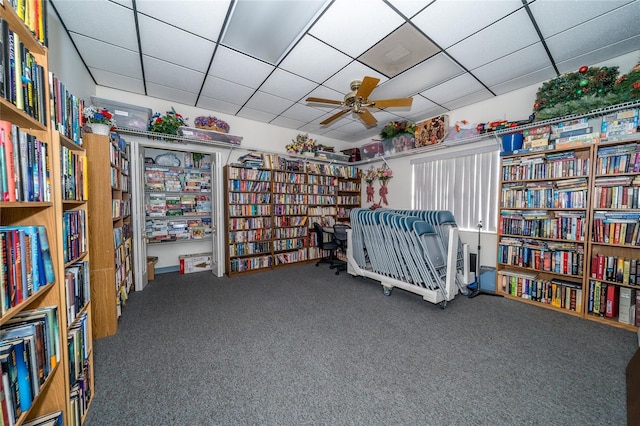 unfurnished room with a drop ceiling, ceiling fan, and carpet