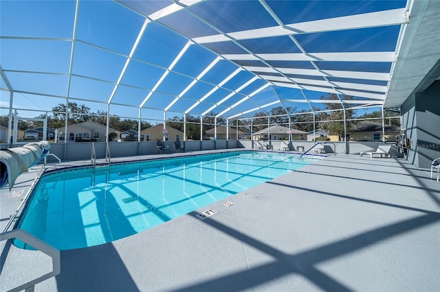 view of pool featuring a patio area and glass enclosure