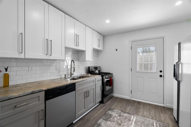 kitchen with appliances with stainless steel finishes, gray cabinets, sink, and white cabinets