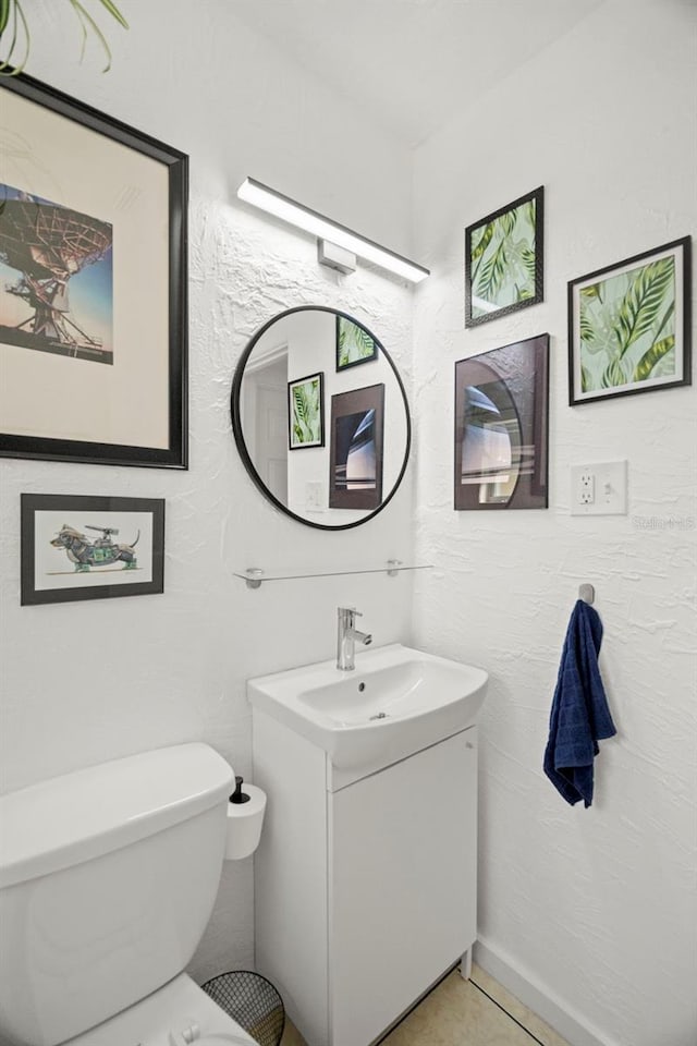 bathroom with vanity, tile patterned floors, and toilet