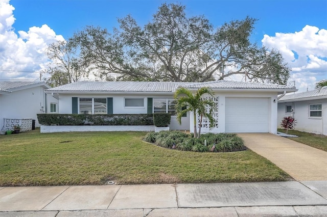 ranch-style home with a garage and a front yard