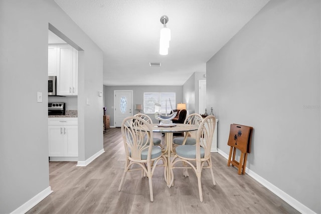 dining area with light hardwood / wood-style flooring