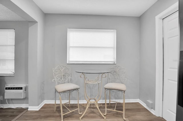 dining area featuring hardwood / wood-style floors and a wall mounted AC