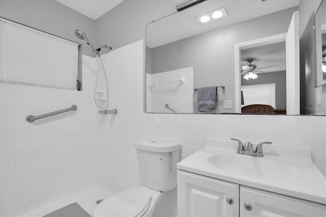 bathroom with ceiling fan, tiled shower, vanity, decorative backsplash, and toilet