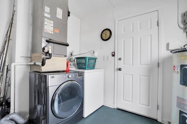 clothes washing area featuring water heater and independent washer and dryer