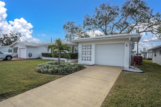 single story home featuring a garage and a front lawn