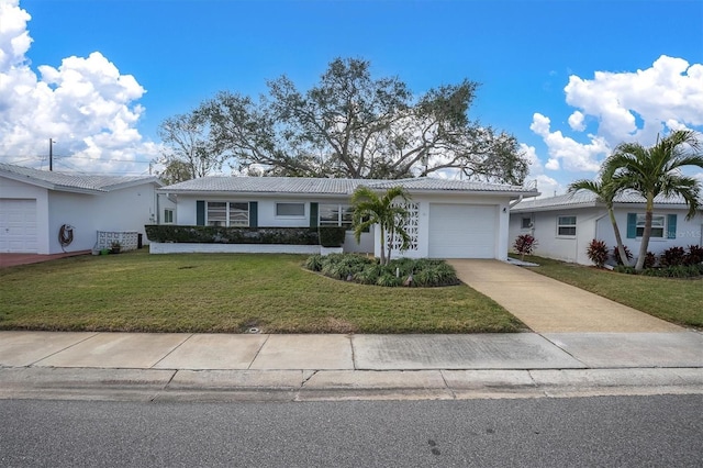 single story home featuring a garage and a front lawn