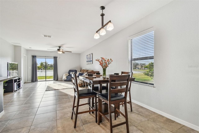 tiled dining space with ceiling fan