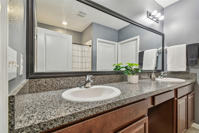 bathroom with vanity and walk in shower