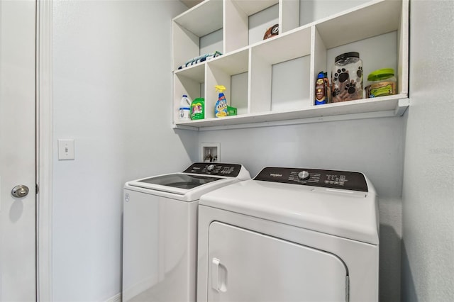 clothes washing area with washing machine and dryer