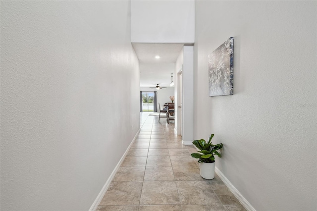 corridor with light tile patterned floors