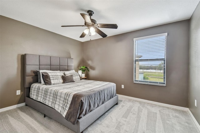 bedroom featuring light colored carpet and ceiling fan