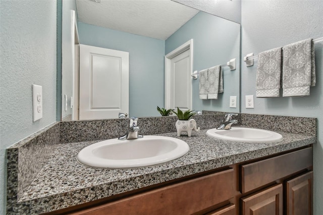 bathroom featuring vanity and a textured ceiling