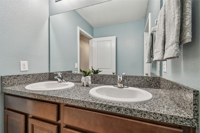 bathroom with vanity and a textured ceiling