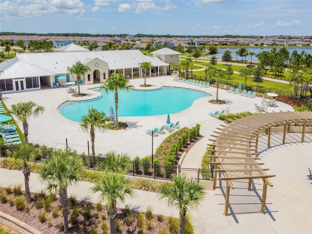 view of pool with a water view and a patio area