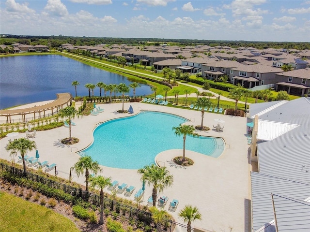 view of pool with a water view and a patio area